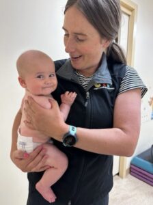 Mom holds baby on hip